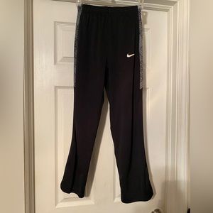 Boys black Nike athletic pants with gray design side panels. Size Large.